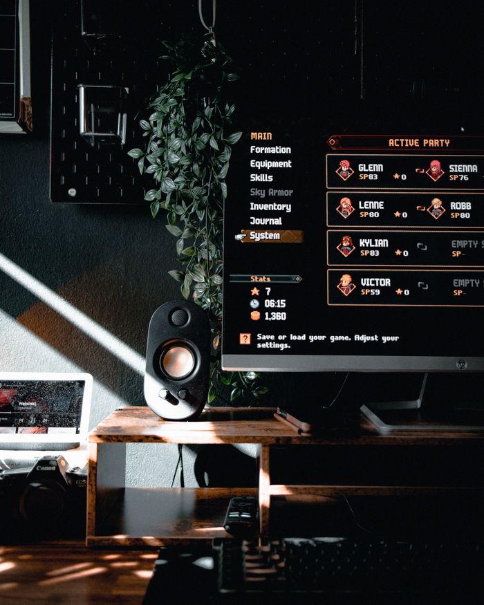 A stylish gaming desk setup featuring a monitor, speaker, and decor elements for immersive experience.